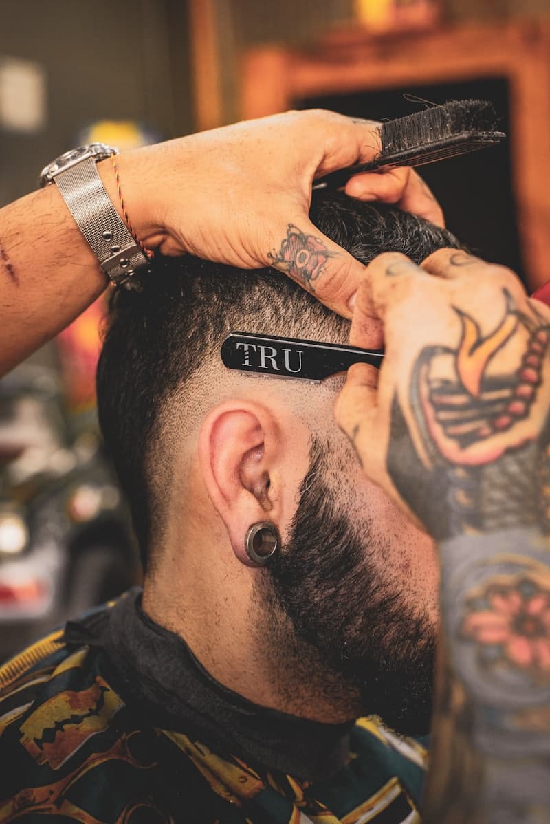 A sharp fade being cut with a comb