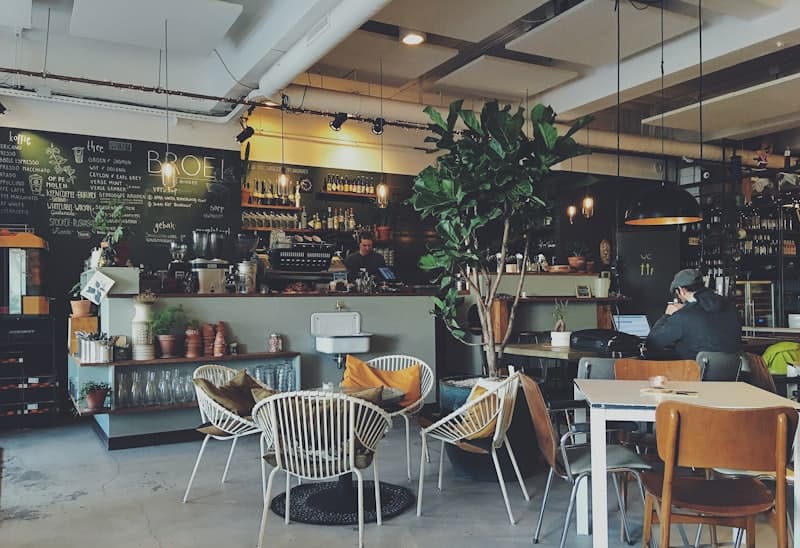 A warm, plant-filled café interior